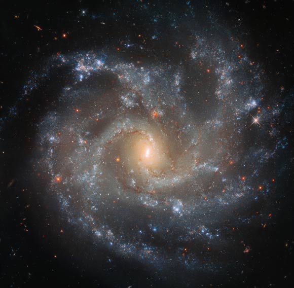 This Hubble image shows the face-on spiral galaxy NGC 5468. The color image was made from separate exposures taken in the visible and infrared regions of the spectrum with Hubble’s Wide Field Camera 3 (WFC3). Four filters were used to sample various wavelengths. The color results from assigning different hues to each monochromatic image associated with an individual filter. Image credit: NASA / ESA / Hubble / W. Li et al / Judy Schmidt, www.geckzilla.com.