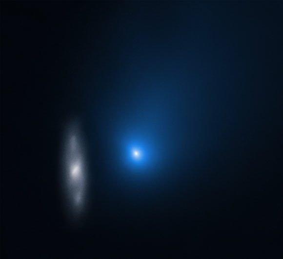 This Hubble image, taken on November 16, 2019, shows the interstellar comet 2I/Borisov in front of the spiral galaxy 2MASX J10500165-0152029. Image credit: NASA / ESA / D. Jewitt, University of California, Los Angeles.