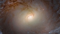 This Hubble image shows the central region of IC 2051, a spiral galaxy located 90 million light-years away in the constellation Mensa. The image is made up of observations from Hubble’s Wide Field Camera 3 (WFC3) in the optical and infrared parts of the spectrum. Three filters were used to sample various wavelengths. The color results from assigning different hues to each monochromatic image associated with an individual filter. Image credit: NASA / ESA / Hubble / P. Erwin et al.