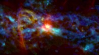 This composite image, which combines infrared (blue), radio (red) and microwave (green) observations from the GISMO instrument, reveals emission from cold dust, areas of vigorous star formation, and filaments formed at the edges of a bubble blown by some powerful event at the Milky Way Galaxy’s center. Image credit: NASA’s Goddard Space Flight Center.