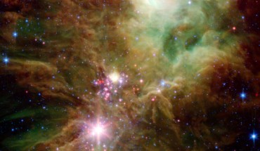 This image from NASA’s Spitzer Space Telescope shows NGC 2264. The newly-revealed protostars appear as pink and red specks toward the center of the image. Image credit: NASA / JPL-Caltech / P.S. Teixeira, Center for Astrophysics.