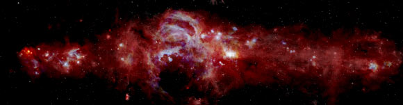 This composite image shows dense swirls of gas and dust in the central region of our Milky Way Galaxy. The image spans 600 light-years across and is helping astronomers learn how many massive stars are forming in the Galactic center. New data from SOFIA taken at 25 and 37 microns, shown in blue and green, are combined with data from ESA’s Herschel Space Observatory, shown in red (70 microns), and NASA’s Spitzer Space Telescope, shown in white (8 microns). Image credit: NASA / SOFIA / JPL-Caltech / ESA / Herschel.