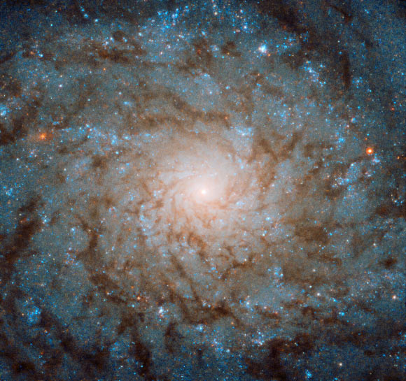 This Hubble image shows the central region of the spiral galaxy NGC 4689. The color image was made from separate exposures taken in the visible and infrared regions of the spectrum with Hubble’s Wide Field Camera 3 (WFC3). It is based on data obtained through three filters. The color results from assigning different hues to each monochromatic image associated with an individual filter. Image credit: NASA / ESA / Hubble.