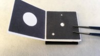 The paper device is folded and unfolded in steps to filter the nucleic acids of pathogens from wastewater samples, then a biochemical reaction with preloaded reagents detects whether the nucleic acid of SARS-CoV-2 infection is present; the results are visible to the naked eye: a green circle indicating positive and a blue circle negative. Image credit: Cranfield University.