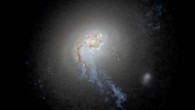 A simulated galaxy image from the FIRE-2 project, representing a structure spanning more than 200,000 light-years, shows the prominent plumes of young blue stars born in gas that was originally rotating and then blown radially outward by supernova explosions. Image credit: Sijie Yu / University of California Irvine.