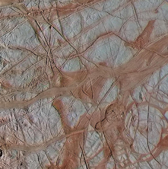 This image of an area called Crisscrossing Bands shows ridges, which may form when a crack in the surface opens and closes repeatedly. In contrast, the smooth bands shown here form where a crack continues pulling apart horizontally, producing large, wide, relatively flat features. Image credit: NASA / JPL-Caltech / SETI Institute.