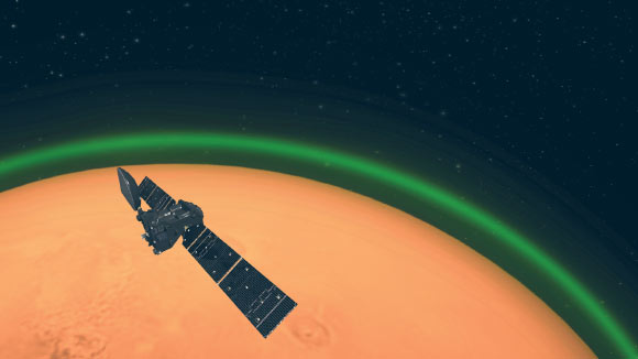An artist’s impression of ESA’s ExoMars Trace Gas Orbiter detecting the green glow of oxygen in the Martian atmosphere. This emission, spotted on the dayside of Mars, is similar to the night glow seen around Earth’s atmosphere from space. Image credit: ESA.