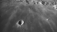 This photograph was taken looking south across Mare Imbrium. The crater Copernicus, 93 km (58 miles) in diameter, is seen in the distance. Several chains of small craters are visible. These are oriented toward Copernicus and are secondary craters produced by material ejected when Copernicus formed. In the foreground, the crater Pytheas is 20 km (12.4 miles) in diameter. This photo was taken by the Apollo 17 crew in 1972. Image credit: Lunar and Planetary Institute.