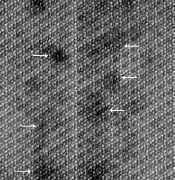 Impurities such as magnesium show up as dark distortions (indicated by white arrows) in the atomic lattice of human enamel crystallites. Image credit: Paul Smeets, Northwestern University & Berit Goodge, Cornell University.