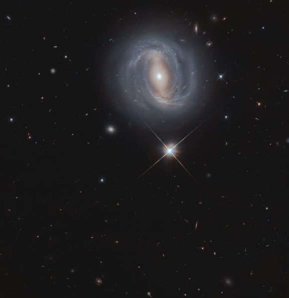 This Hubble image shows NGC 4907, a barred spiral galaxy located 284 million light-years away in the constellation of Coma Berenices. The image is a composite of separate exposures acquired by Hubble’s Wide Field Camera 3 (WFC3). Two filters were used to sample various wavelengths. The color results from assigning different hues to each monochromatic image associated with an individual filter. Image credit: NASA / ESA / Hubble / M. Gregg.