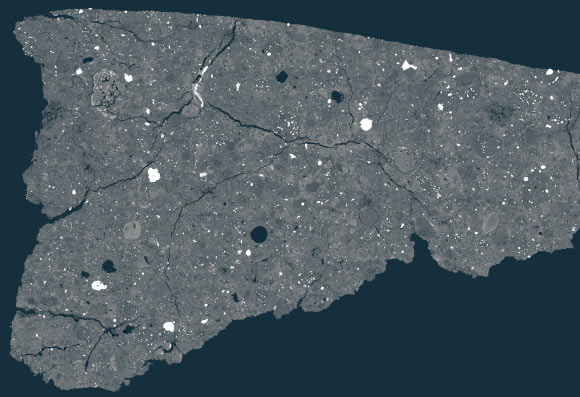 This SEM image shows a polished thin section of Asuka 12236. The section is about 1 cm (a third of an inch) across. Most of the bright grains in the image are iron-nickel-metal and/or iron-sulfide. The gray is mostly silicate, with the darker gray areas more magnesium-rich, while the lighter gray areas are more iron-rich. The roundish objects, and some fragments of them, that tend to contain most of the small, bright metal grains are called chondrules, which formed as molten droplets. They are set in a very fine-grained matrix, which is where the organic compounds and presolar grains are found. Image credit: Carnegie Institution for Science / Conel M. O’D. Alexander.
