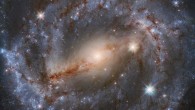 This Hubble image shows NGC 5643, a grand design spiral galaxy some 55 million light-years away in the constellation of Lupus. The color image is composed of infrared and optical observations from Hubble’s Wide Field Camera 3 (WFC3). It is based on data obtained through four filters. The color results from assigning different hues to each monochromatic image associated with an individual filter. Image credit: NASA / ESA / Hubble / A. Riess et al / Mahdi Zamani.