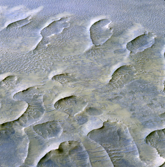 This oblique color view from the HiRISE instrument onboard NASA’s Mars Reconnaissance Orbiter shows a lithified field of sand dunes within Melas Chasma, Valles Marineris. The large degree of preserved morphology for many of these paleodunes reveals important information regarding the acting wind regime and climate prior to their cementation. Image credit: NASA / JPL / University of Arizona.
