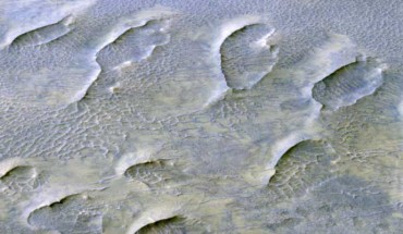This oblique color view from the HiRISE instrument onboard NASA’s Mars Reconnaissance Orbiter shows a lithified field of sand dunes within Melas Chasma, Valles Marineris. The large degree of preserved morphology for many of these paleodunes reveals important information regarding the acting wind regime and climate prior to their cementation. Image credit: NASA / JPL / University of Arizona.