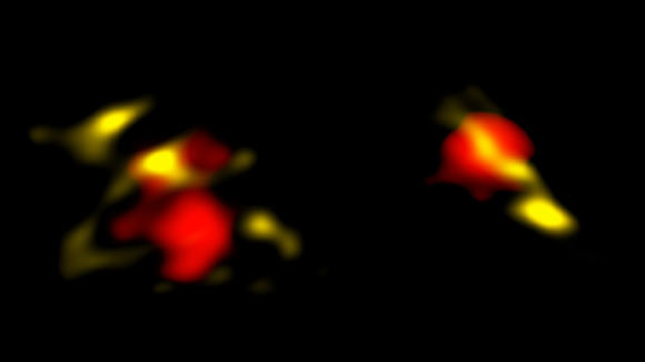 These are two of the galaxies in the early Universe that ALMA observed in radio waves; these galaxies are considered more ‘mature’ than ‘primordial’ because they contain large amounts of dust (yellow); ALMA also revealed gas (red), which is used to measure the obscured star-formation and motions in the galaxies. Image credit: B. Saxton / NRAO / AUI / NSF / ESO / NASA / STScI / NAOJ / ALPINE Team.