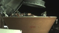 This image shows OSIRIS-REx’s collector head hovering over the Sample Return Capsule after the Touch-And-Go Sample Acquisition Mechanism arm moved it into the proper position for capture. Image credit: NASA’s Goddard Space Flight Center / University of Arizona / Lockheed Martin.