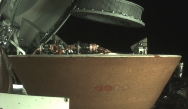 This image shows OSIRIS-REx’s collector head hovering over the Sample Return Capsule after the Touch-And-Go Sample Acquisition Mechanism arm moved it into the proper position for capture. Image credit: NASA’s Goddard Space Flight Center / University of Arizona / Lockheed Martin.