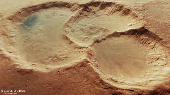 This image provides a perspective view of a triple crater in Noachis Terra, Mars. Image credit: ESA / DLR / FU Berlin / CC BY-SA 3.0 IGO.