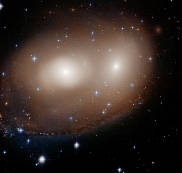 This unusual celestial object, as seen by the NASA/ESA Hubble Space Telescope, is actually a combination of two lenticular galaxies, NGC 2292 and NGC 2293. Image credit: NASA / ESA / Hubble / W. Keel, University of Alabama.
