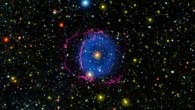 The Blue Ring Nebula is located 6,197 light-years away in the constellation of Hercules. The nebula is 13 light years wide and is composed of hydrogen gas (blue) expanding from a central star, which is the remnant core of a stellar merger; red filaments are shockwave filaments from the merging event. Image credit: NASA / JPL-Caltech / M. Seibert, Carnegie Institution for Science / K. Hoadley, Caltech / GALEX Team.