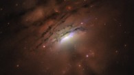 This Hubble image of the nearby active galaxy IC 5063 reveals a mixture of bright rays and dark shadows coming from the blazing core, home of a supermassive black hole. Image credit: Credits: NASA / ESA / Hubble / STScI / W.P. Maksym, CfA.