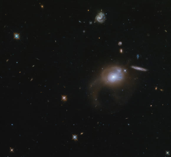 This Hubble image shows a galaxy called SDSS J225506.80+005839.9 (visible in the center right portion of the image). Image credit: NASA / ESA / Hubble / A. Zabludoff.