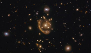 This Hubble image shows GAL-CLUS-022058-38303, the largest, nearly-complete Einstein ring known. The image is made up of observations from Hubble’s Wide Field Camera 3 (WFC3) in the infrared and optical parts of the spectrum. Three filters were used to sample various wavelengths. The color results from assigning different hues to each monochromatic image associated with an individual filter. Image credit: NASA / ESA / Hubble / Saurabh Jha, Rutgers the State University of New Jersey / L. Shatz.