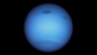 This Hubble image of the dynamic blue-green planet Neptune reveals a huge dark storm (top center) and the emergence of a smaller dark spot nearby (top right). The giant vortex, which is wider than the Atlantic Ocean, was traveling south toward certain doom by atmospheric forces at the equator when it suddenly made a U-turn and began drifting back northward. Hubble’s Wide Field Camera 3 (WFC3) captured this visible-light image on January 7, 2020, the same time a slightly smaller dark spot mysteriously appeared nearby. That spot then vanished a few months later. The smaller feature may have been a piece of the giant storm that broke off as the larger vortex approached the equator. The large storm is the fourth transient dark spot Hubble has observed since 1993. NASA’s Voyager 2 spacecraft first imaged two dark features in Neptune’s southern hemisphere in 1989 as Voyager flew by the distant planet. Those storms had disappeared by the time Hubble looked at Neptune in 1994. However, Hubble detected two new dark spots in the planet’s northern hemisphere in 1994 and 1996. Image credit: NASA / ESA / STScI / M.H. Wong, University of California, Berkeley / L.A. Sromovsky & P.M. Fry, University of Wisconsin-Madison.