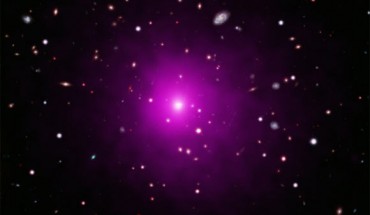 This image of Abell 2261, a galaxy cluster located 3 billion light-years away, contain X-ray data from Chandra showing hot gas pervading the cluster as well as optical data from Hubble and the Subaru Telescope that show galaxies in the cluster and in the background. A2261-BCG (center), also known as 2MASX J17222717+3207571, is the most massive and brightest galaxy in the cluster. Image credit: NASA / CXC / University of Michigan / K. Gültekin / STScI / NAOJ / Subaru / NSF / NOAO / KPNO.