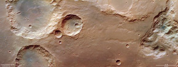 This image from the High Resolution Stereo Camera (HRSC) aboard ESA’s Mars Express shows craters, valleys and chaotic terrain in Pyrrhae Regio, Mars. Chaotic terrain forms as a shifting subsurface layer of melting ice and sediment causes the surface above to collapse. In the chaotic terrain seen here, ice has melted, the resulting water drained away, and a number of disparate broken blocks have been left standing in now-empty cavities (which once hosted ice). This image comprises data gathered by HRSC on August 3, 2020. Image credit: ESA / DLR / FU Berlin / CC BY-SA 3.0 IGO.