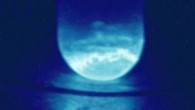 Quartz vial containing 300 micrograms of einsteinium-253. The illumination produced is a result of the intense radiation from einsteinium-253, which alpha decays with a half-life of 20.5 days. Image credit: R.G. Haire, U.S. Department of Energy.