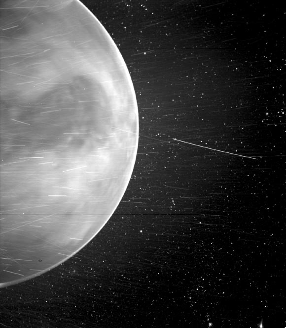 When flying past Venus on July 11, 2020, the WISPR instrument onboard Parker Solar Probe detected a bright rim around the edge of the planet that may be nightglow. The prominent dark feature in the center of the image is Aphrodite Terra, the largest highland region on the Venusian surface. Bright streaks in WISPR, such as the ones seen here, are typically caused by a combination of cosmic rays, sunlight reflected by grains of space dust, and particles of material expelled from the spacecraft’s structures after impact with those dust grains. The number of streaks varies along the orbit or when the spacecraft is traveling at different speeds, and scientists are still in discussion about the specific origins of the streaks here. The dark spot appearing on the lower portion of Venus is an artifact from the WISPR instrument. Image credit: NASA / Johns Hopkins Applied Physics Laboratory / Naval Research Laboratory / Guillermo Stenborg / Brendan Gallagher.