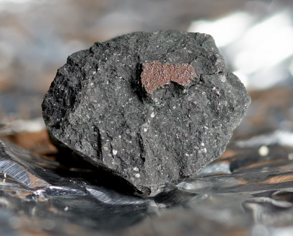 A fragment of the Winchcombe meteorite. Image credit: Trustees of the Natural History Museum, London.