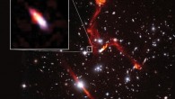This composite image, taken by the Very Large Array and Hubble, shows the galaxy cluster MACS J0717.5+3745. Pullout shows the distant galaxy J0717+3745, far beyond the cluster, and likely the faintest radio-emitting object ever detected. The prominent red-orange objects are radio relics -- large structures possibly caused by shock waves -- inside MACS J0717.5+3745. Image credit: Heywood et al. / Sophia Dagnello, NRAO / AUI / NSF / STScI.