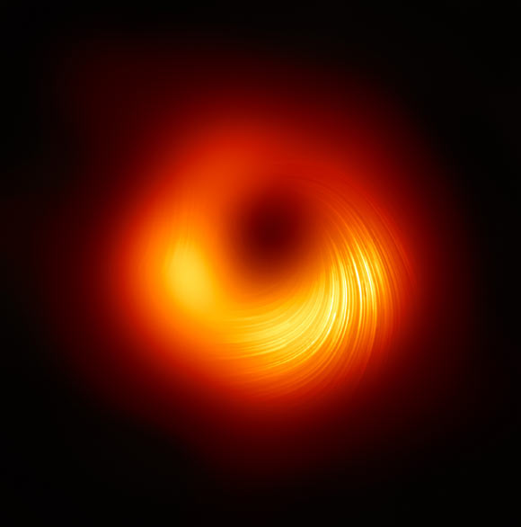 This EHT image shows the polarized view of the black hole in Messier 87. The lines mark the orientation of polarization, which is related to the magnetic field around the shadow of the black hole. Image credit: EHT Collaboration.