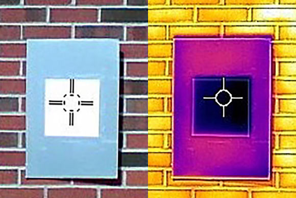 An infrared camera shows how a sample of the whitest white paint (the dark purple square in the middle) actually cools the board below ambient temperature, something that not even commercial ‘heat rejecting’ paints do. Image credit: Joseph Peoples / Purdue University.