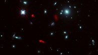 This composite image, taken by the NASA/ESA Hubble Space Telescope and ALMA, shows the galaxy cluster RXCJ0600-2007 and lensed images of the galaxy RXCJ0600-z6 (red). Image credit: ALMA / ESO / NAOJ / NRAO / Fujimoto et al. / NASA / ESA / Hubble Team.