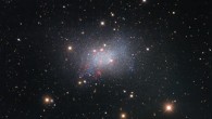 This image of the irregular dwarf galaxy Sextans B, taken by the Nicholas U. Mayall 4-m Telescope, features red-colored star-forming regions near the galaxy’s center; surrounding the galaxy are several bright stars that are located much closer to us in our Milky Way Galaxy, identified by the crisscross patterns created by light interacting with the structure of the telescope, as well as numerous fuzzy-looking background galaxies that appear small because they are much farther away than Sextans B. Image credit: KPNO / NOIRLab / NSF / AURA / P. Massey, Lowell Observatory / G. Jacoby / K. Olsen / C. Smith, AURA & NSF / T.A. Rector, University of Alaska Anchorage & NSF’s NOIRLab / M. Zamani, NSF’s NOIRLab / D. de Martin, NSF’s NOIRLab.