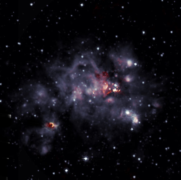 This overlay shows radio (orange) and infrared images of the giant molecular cloud W49A, where new stars are being formed. Image credit:  De Pree et al. / Sophia Dagnello, NRAO / AUI / NSF / Spitzer / NASA.
