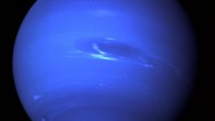 This picture of Neptune was produced from the last whole planet images taken through the green and orange filters on the narrow angle camera of NASA’s Voyager 2 spacecraft. The images were taken at a range of 7.1 million km (4.4 million miles) from the planet, 4 days and 20 hours before closest approach. The picture shows the Great Dark Spot and its companion bright smudge; on the west limb the fast moving bright feature called Scooter and the little dark spot are visible. These clouds were seen to persist for as long as Voyager’s cameras could resolve them. North of these, a bright cloud band similar to the south polar streak may be seen. Image credit: NASA / JPL.