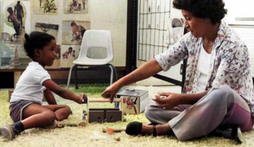 A teacher guides a student through a task in this historical photo of the Abecedarian Project. Image credit: Virginia Tech.