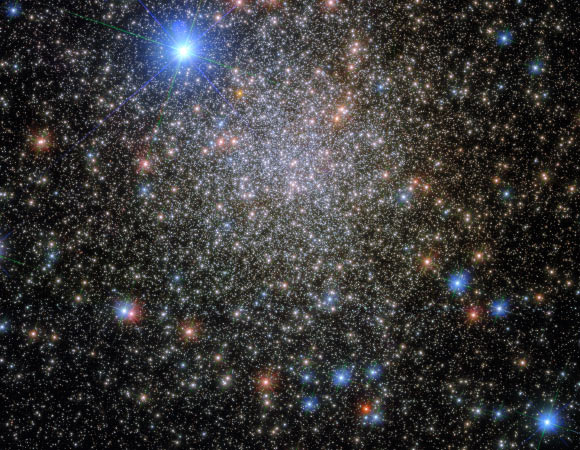 This Hubble image shows NGC 6380, a globular cluster some 35,500 light-years away in the constellation of Scorpius. The very bright star at the top of the image is HD 159073, which is only around 4,000 light-years from Earth. The color image was made from separate exposures taken in the visible and near-infrared regions of the spectrum with Hubble’s Wide Field Camera 3 (WFC3). Three filters were used to sample various wavelengths. The color results from assigning different hues to each monochromatic image associated with an individual filter. Image credit: NASA / ESA / Hubble / E. Noyola.