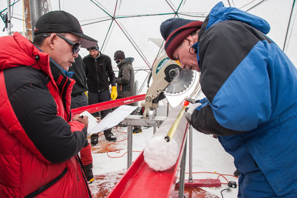 Yao Tandong, left, and Lonnie Thompson, right, process an ice core drilled from the Guliya ice cap in the Tibetan Plateau in 2015. Image credit: Lonnie Thompson.