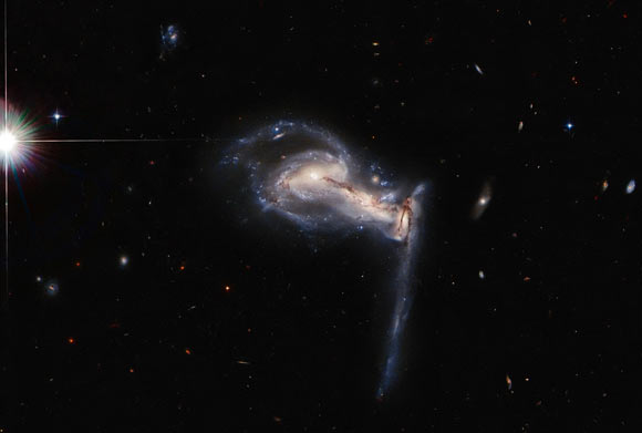 This Hubble image shows the triple galaxy system Arp 195. Image credit: NASA / ESA / Hubble / J. Dalcanton.