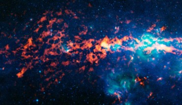 Sagittarius B2 is a giant molecular cloud of gas and dust that is located about 390 light-years from the center of the Milky Way Galaxy. Sagittarius B2 is the bright orange-red region to the middle left of the image, which is centered on the Galactic center. Image credit: ESO / APEX / MSX / IPAC / NASA.