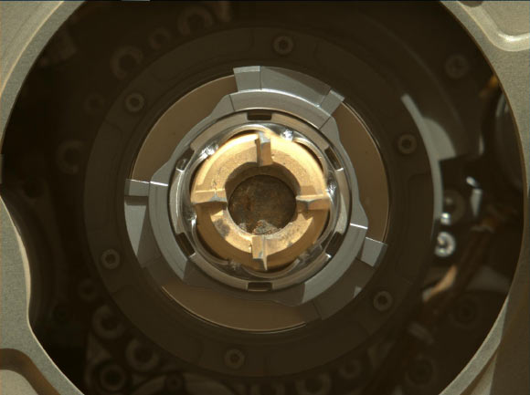 This Mastcam-Z image shows a sample of Mars rock inside the sample tube on September 1, 2021 (the 190th sol, or Martian day, of the mission), shortly after the coring operation. The image was taken after coring concluded but prior to an operation that vibrates the drill bit and tube to clear the tube’s lip of any residual material. The bronze-colored outer-ring is the coring bit. The lighter-colored inner-ring is the open end of the sample tube, and inside is a rock core sample slightly thicker than a pencil. A portion of the tube’s serial number -- 266 -- can be seen on the top side of tube’s wall. Image credit: NASA / JPL-Caltech / ASU / MSSS.