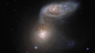 This composite image shows the interacting galaxy system Arp 91. The color image is made up of observations from Hubble’s Advanced Camera for Surveys (ACS), the Dark Energy Camera (DECam) on the Victor M. Blanco 4-m Telescope and the Sloan Digital Sky Survey (SDSS) in the optical part of the spectrum. Seven filters were used to sample various wavelengths. The color results from assigning different hues to each monochromatic image associated with an individual filter. Image credit: NASA / ESA / Hubble / J. Dalcanton / J. Schmidt.