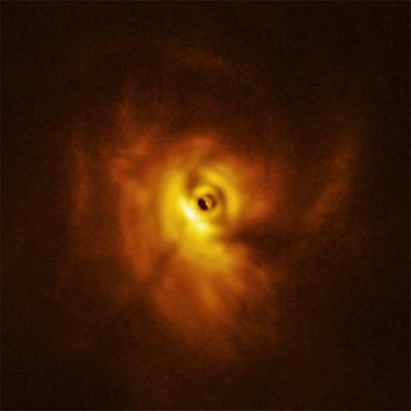 This ALMA image shows the shadow of the innermost ring on the rest of the circumtriple protoplanetary disk around GW Orionis. Image credit: ALMA / ESO / NAOJ / NRAO / University of Exeter / Kraus et al.