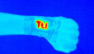An electrically conductive and durable yarn was sewn onto fabric and became a wearable heater (high temperatures indicated by yellows and reds) when a safe voltage was applied. Image credit: Pattanarat et al., doi: 10.1021/acsami.1c13329.