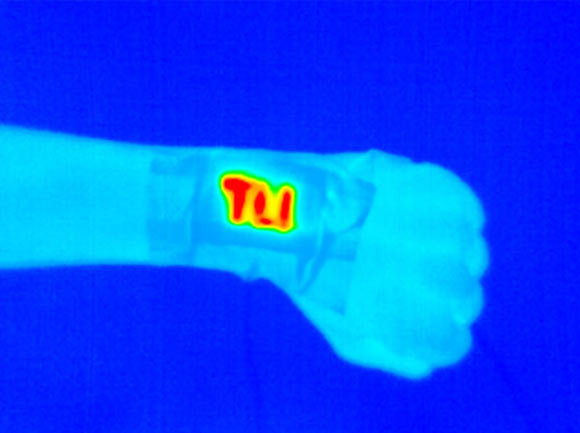 An electrically conductive and durable yarn was sewn onto fabric and became a wearable heater (high temperatures indicated by yellows and reds) when a safe voltage was applied. Image credit: Pattanarat et al., doi: 10.1021/acsami.1c13329.